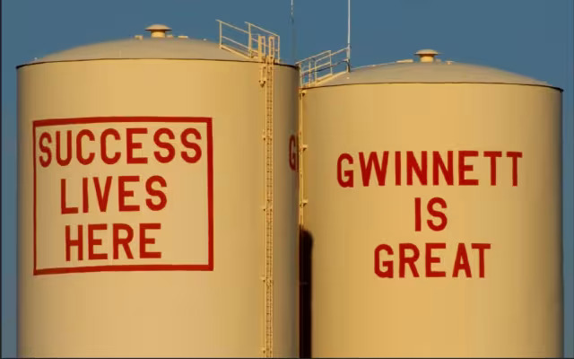 Gwinnett County water towers reading Success Lives Here and Gwinnett Is Great